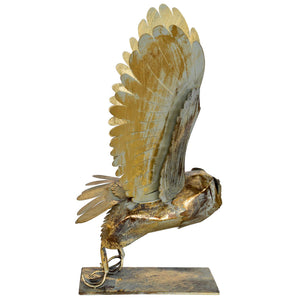 Gold and bronze eagle sculpture on a white background