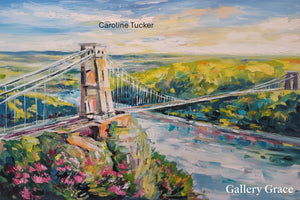 Painting of a suspension bridge with scenic landscape, artist 'Caroline Tucker', and 'Gallery Grace' text.