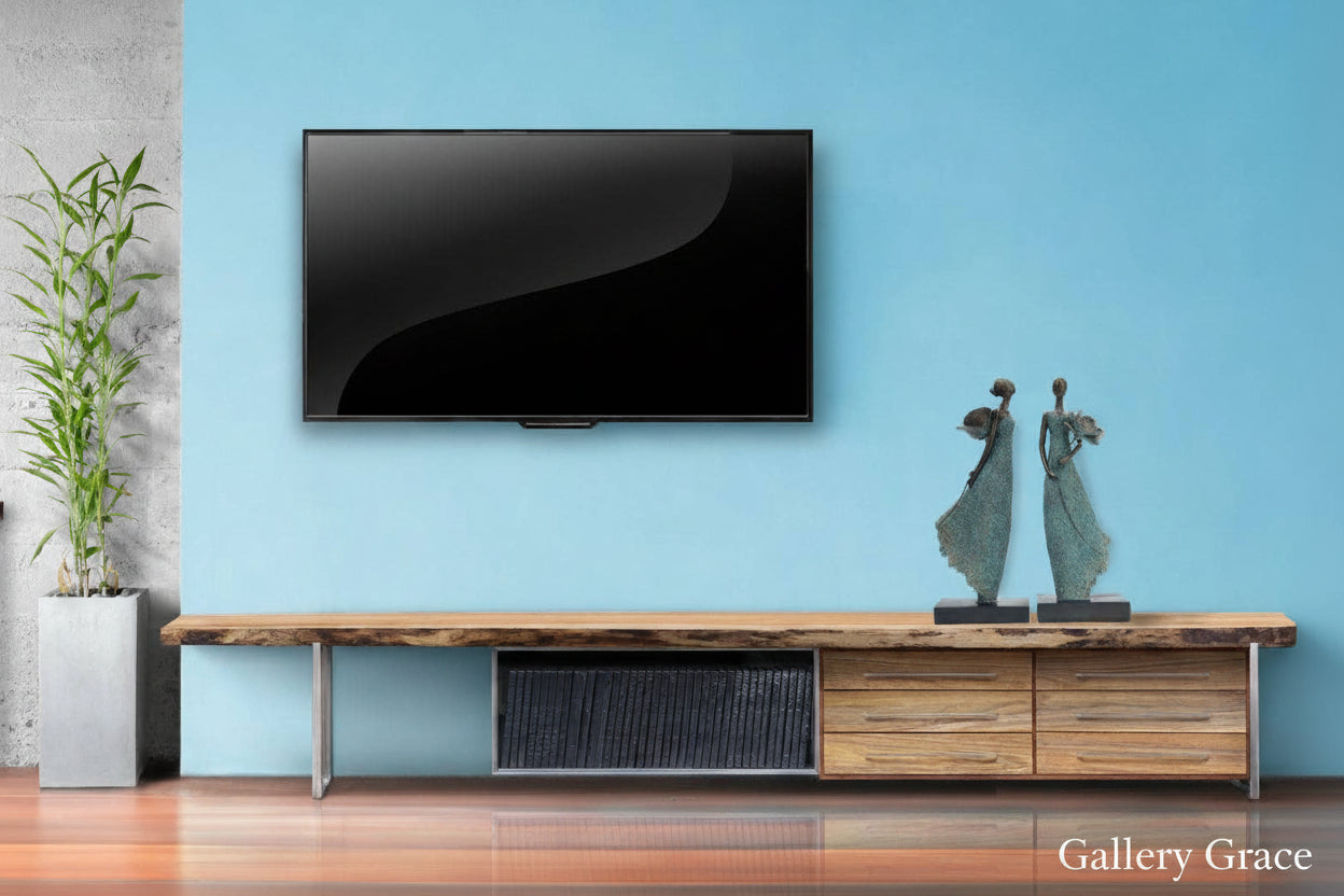 Modern living room with a flat-screen TV mounted on a light blue wall, wooden console table, and decorative items.
