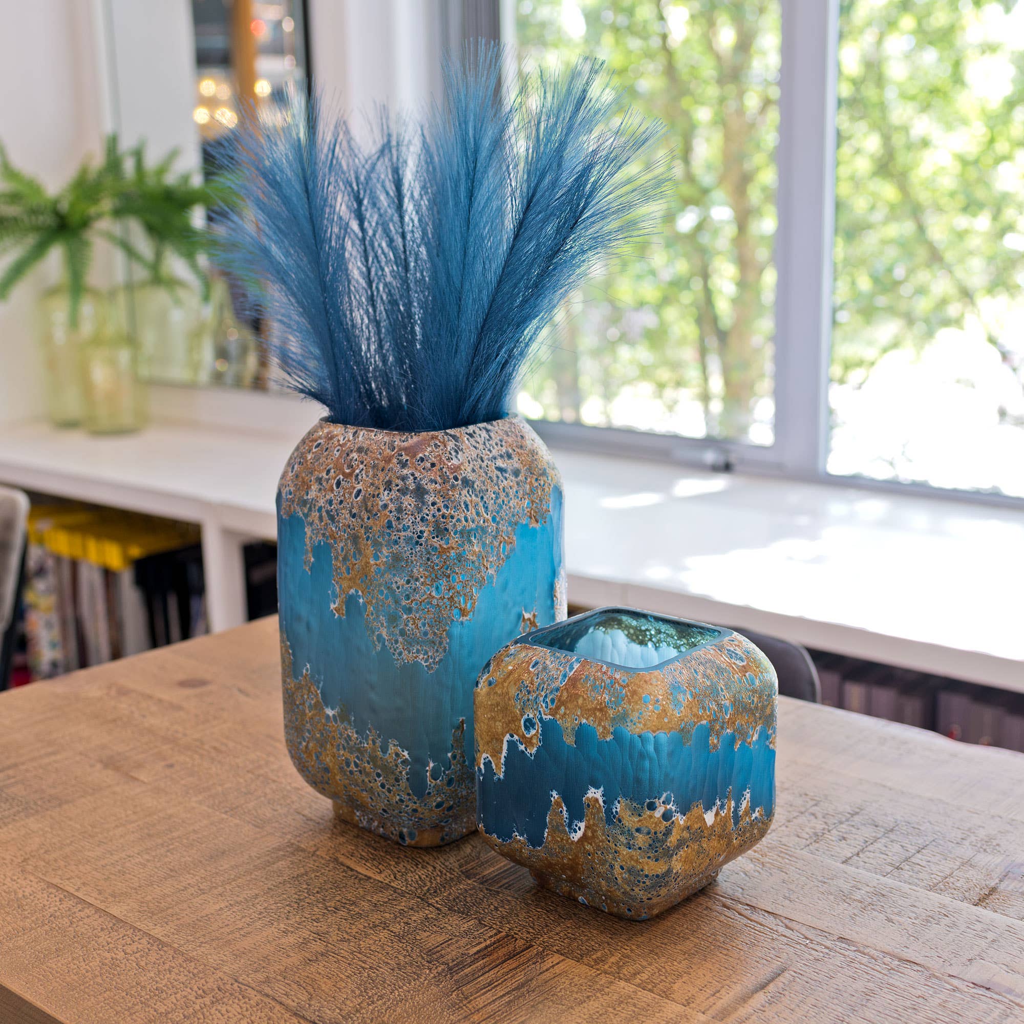 Decorative cube vase with white and brown speckled pattern on a blue background