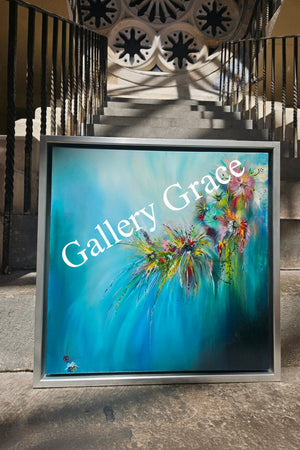Colorful abstract painting in a silver frame on a textured wall.