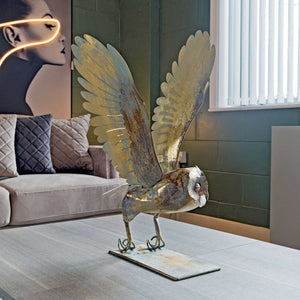 Decorative metal bird sculpture in a living room setting